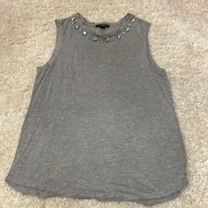 Muscle tea with embellishments around the neck size medium